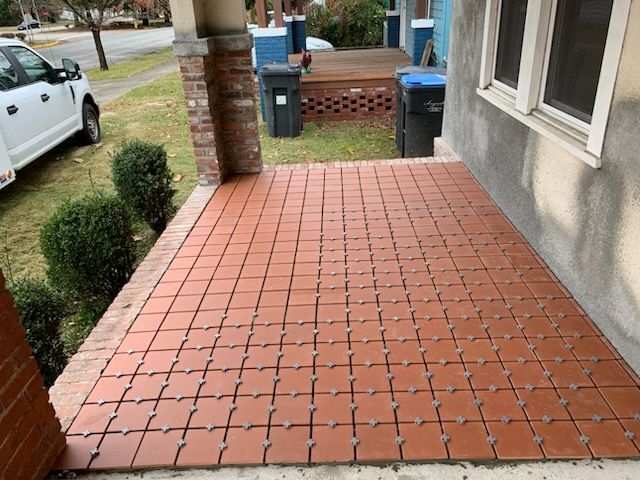 A brick porch with a white truck parked in front of it
