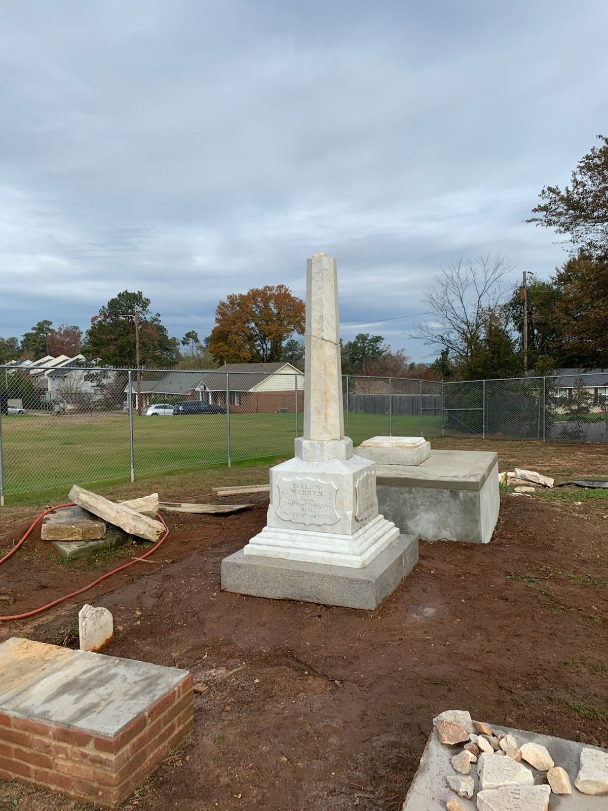 A graveyard with a statue in the middle of it.