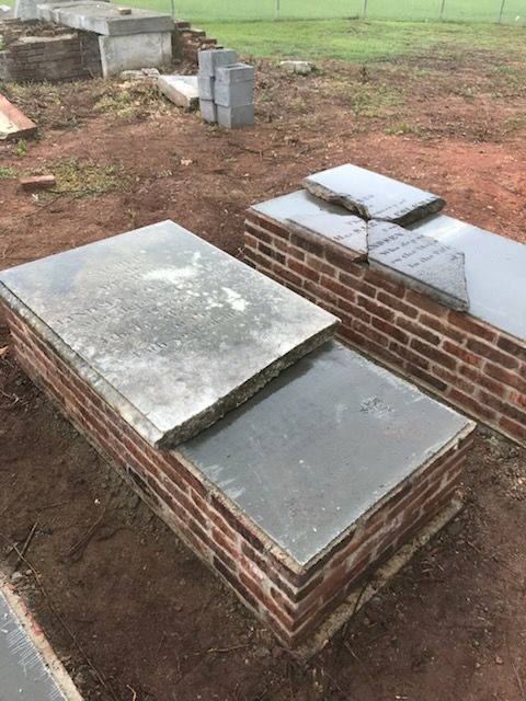 Two graves in a cemetery are made of bricks