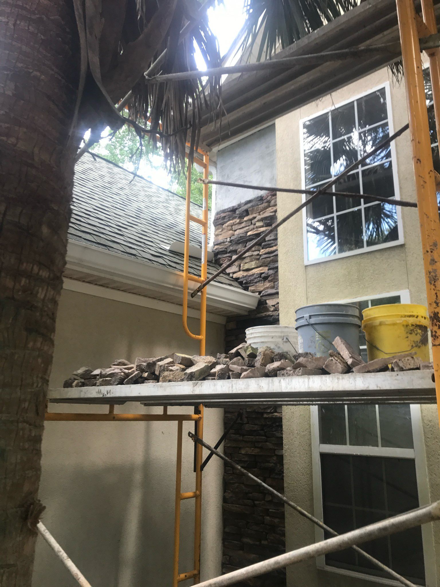 A scaffolding is sitting in front of a house under construction.