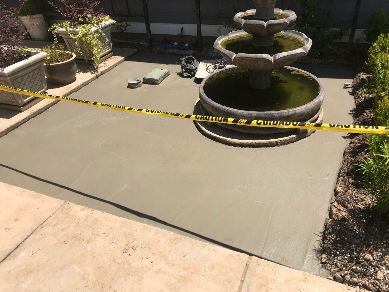 A fountain is surrounded by yellow tape that says caution
