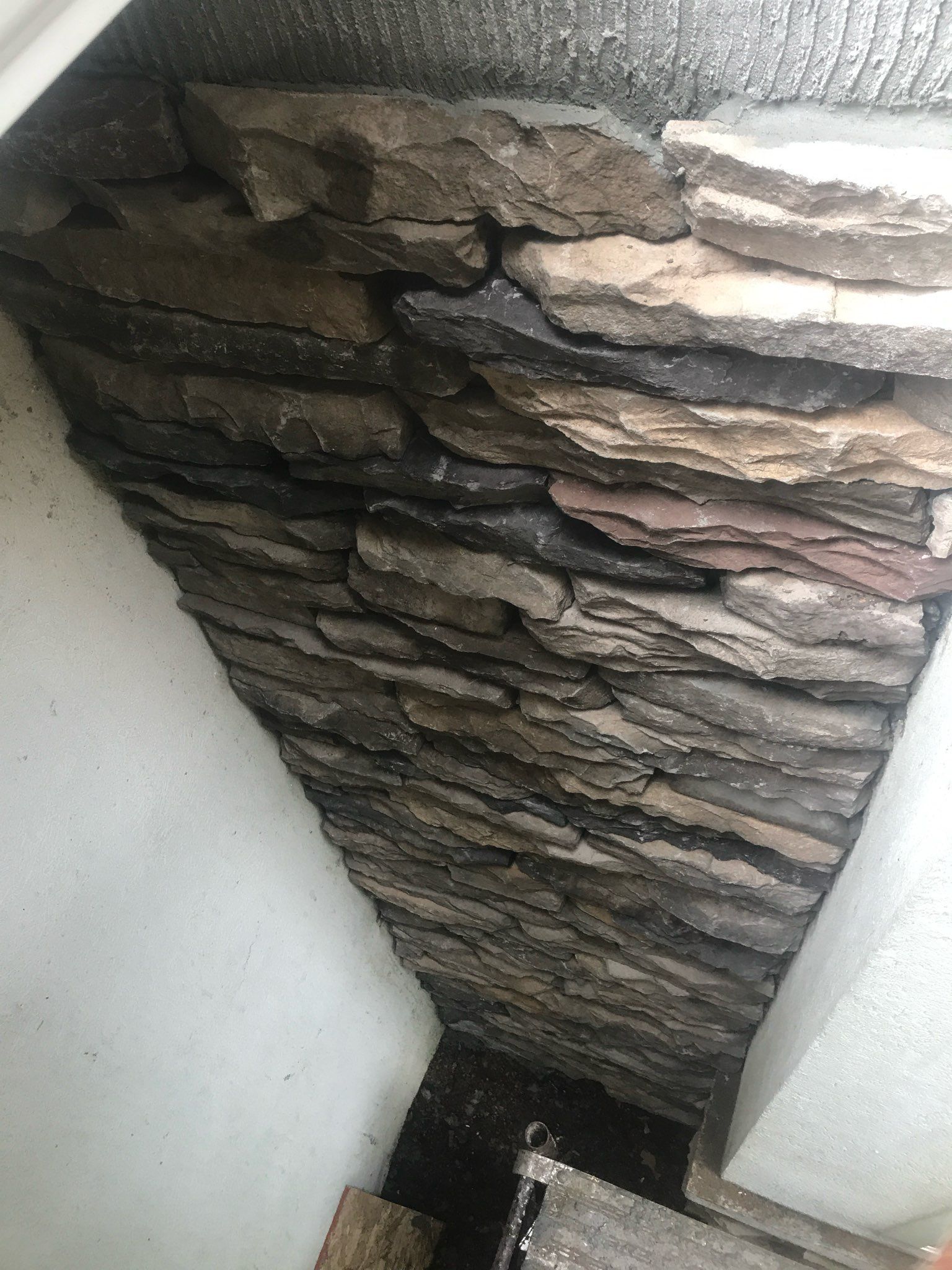 A pile of rocks stacked on top of each other on a wall.