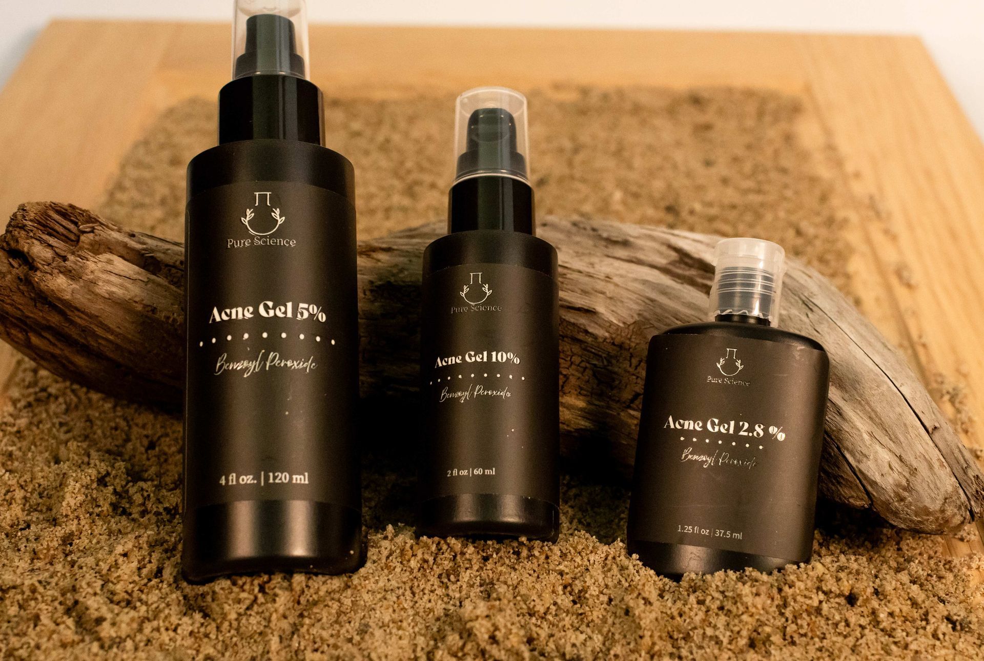 Four brown skincare product bottles with white caps and dispensers.