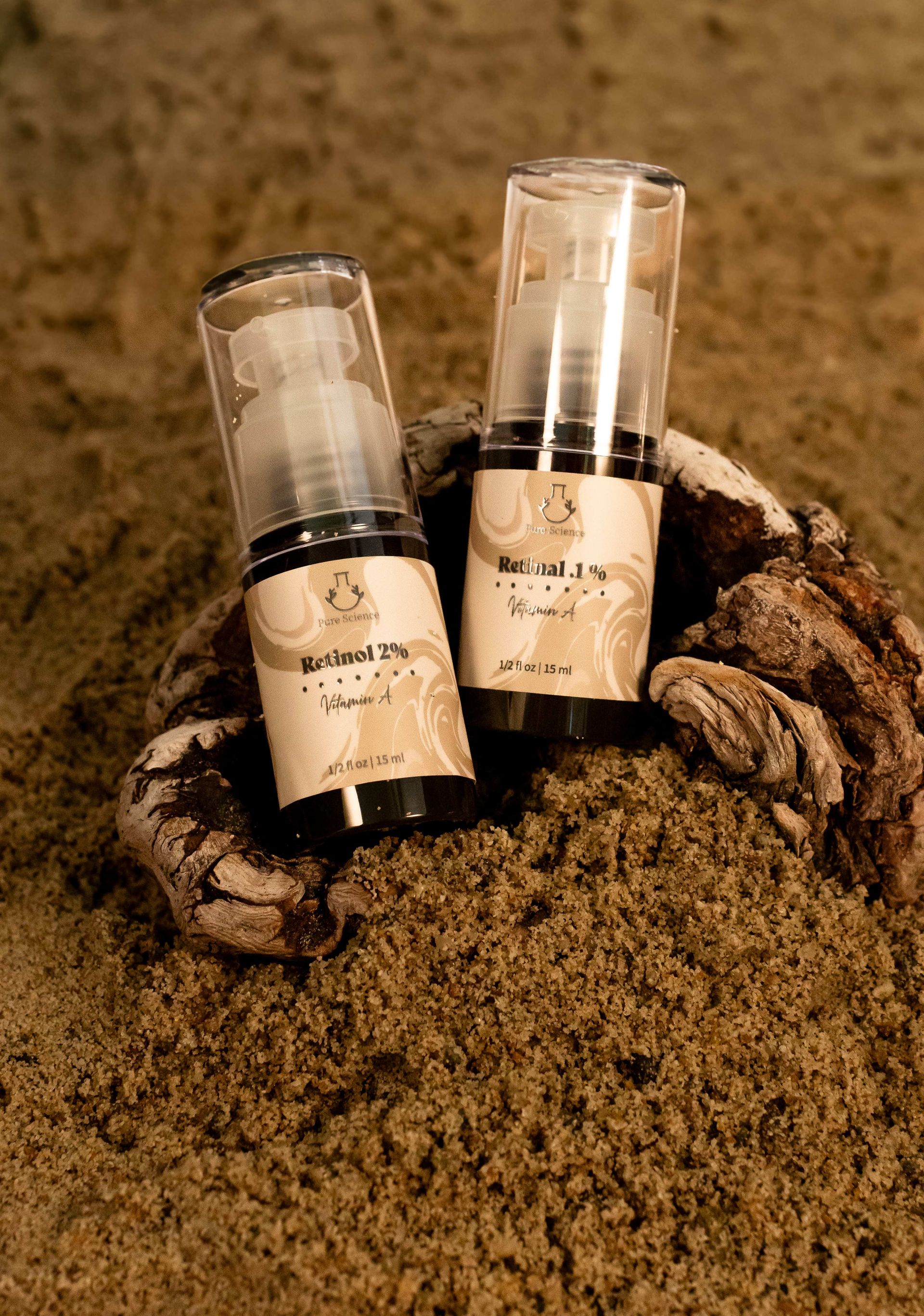 Four brown skincare product bottles with white caps and dispensers.