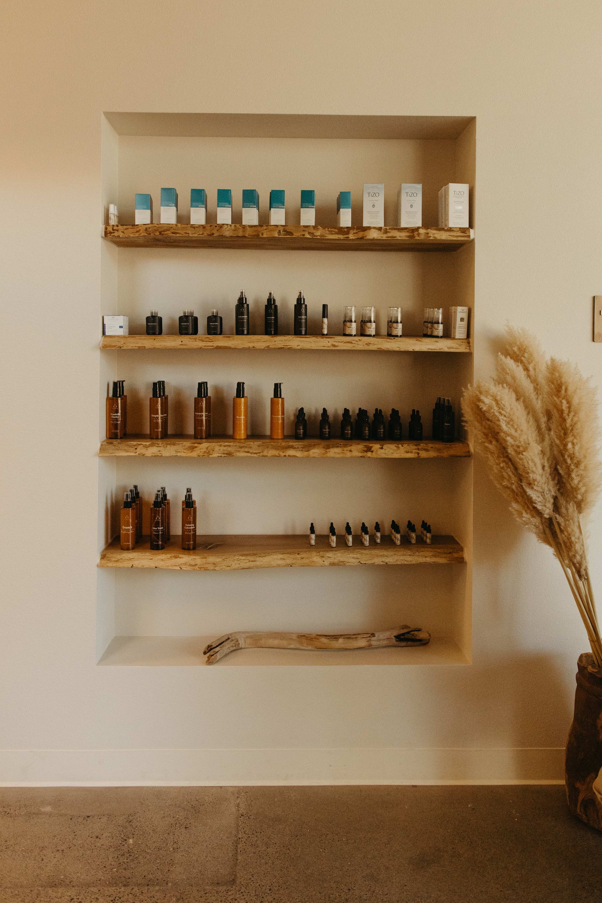 Four brown skincare product bottles with white caps and dispensers.