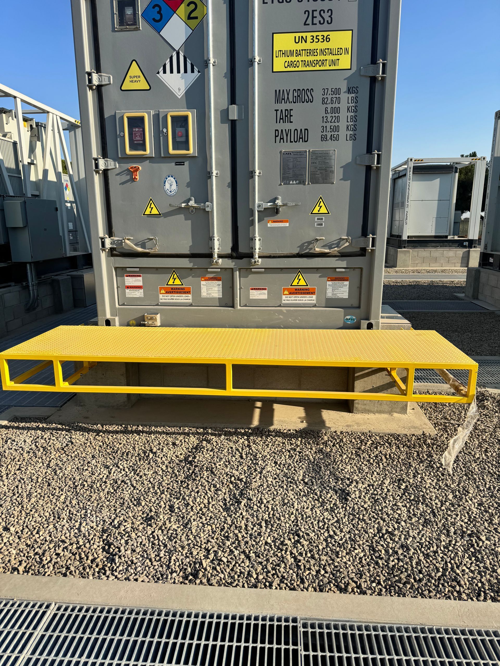 A close up of a suspension system on a truck with a tire in the background.