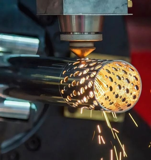 A machine is cutting a metal pipe with sparks coming out of it