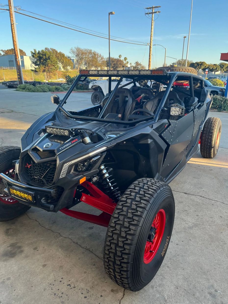 A black and red atv is parked in a parking lot.