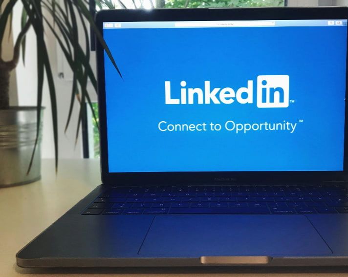 A laptop with the linkedin logo on the screen