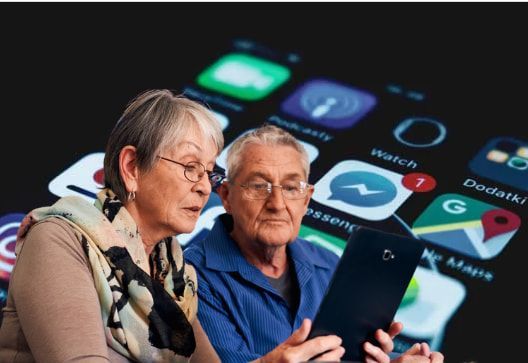 A man and a woman are looking at a tablet.