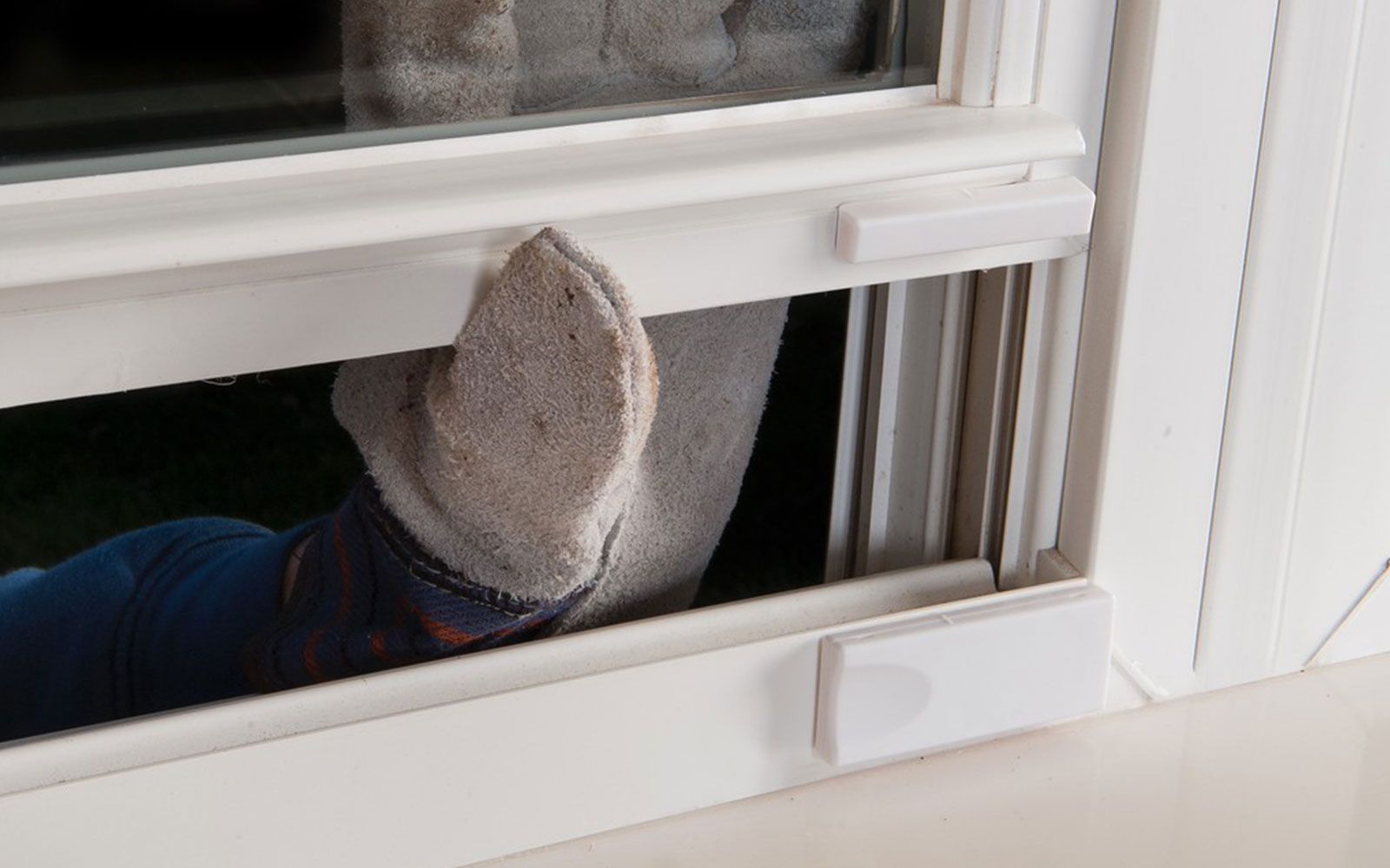 A person 's foot is sticking out of a window.