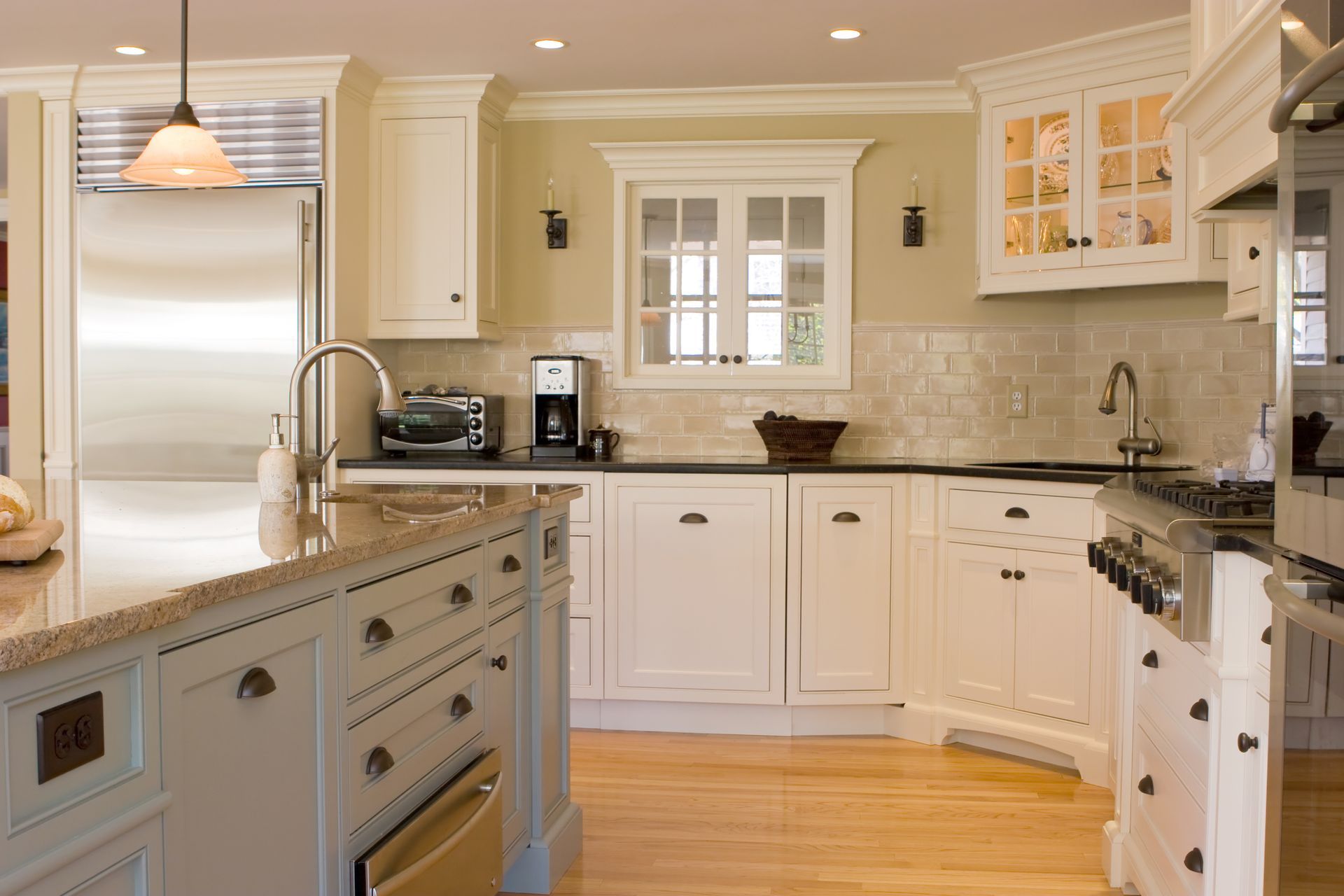 A kitchen with white cabinets and stainless steel appliances