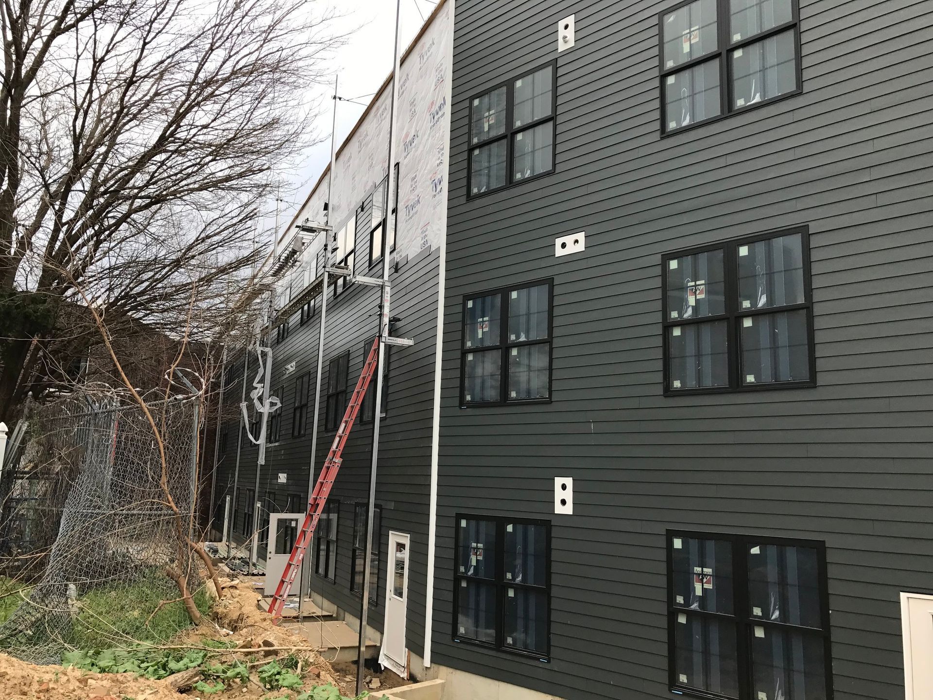 A large building with a lot of windows is under construction.