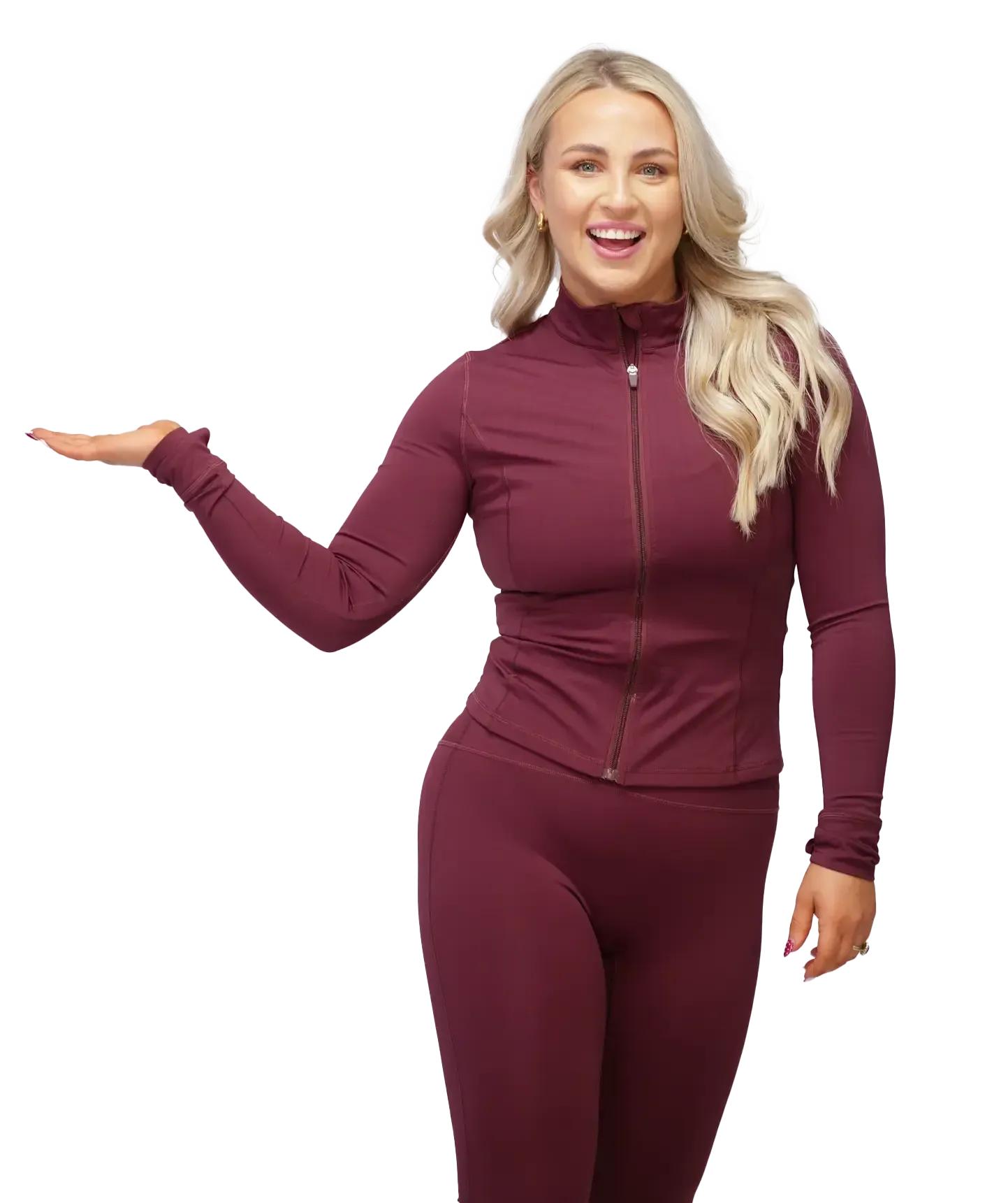 Woman in burgundy athletic wear gesturing with open hand, smiling.