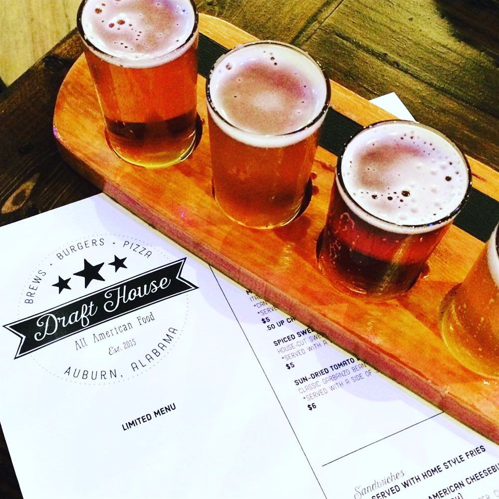 A variety of drinks are sitting on a wooden table.