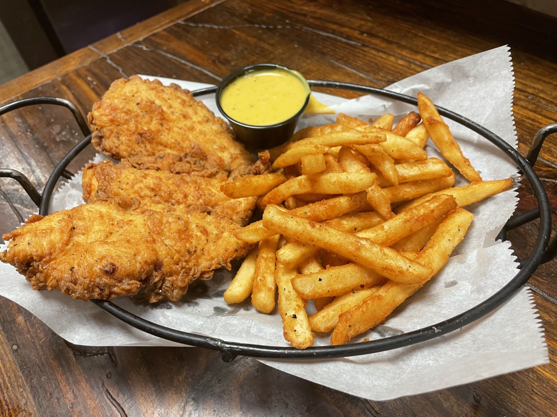 A white plate topped with mashed potatoes , chicken , and green onions.