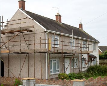 a house is being remodeled with scaffolding around it.