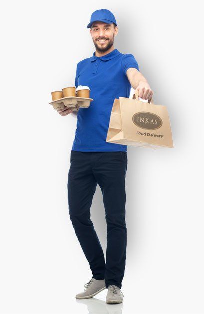 Delivery person in blue uniform holding coffee tray and food bag, smiling.