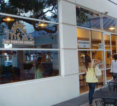 Inca's restaurant storefront with glass windows, signage, and people walking.