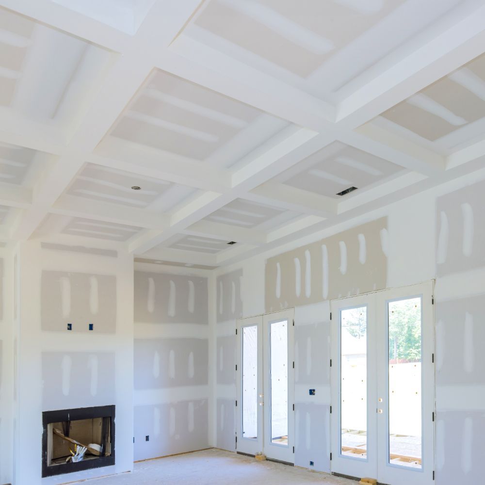 An empty room with a fireplace and lots of windows