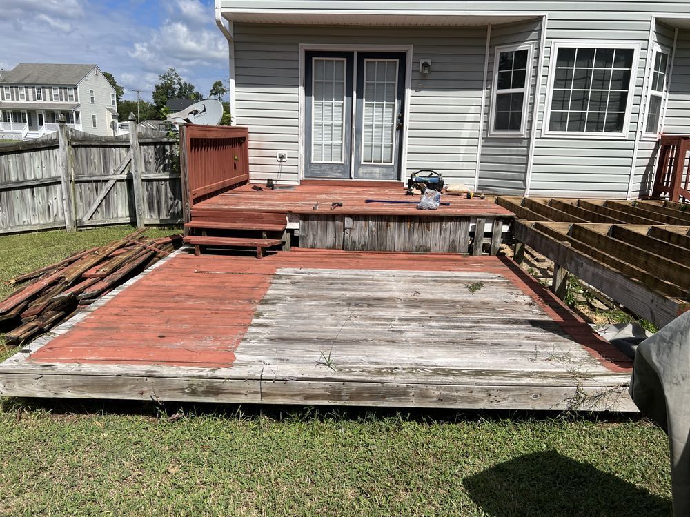 A wooden deck is being built in the backyard of a house.