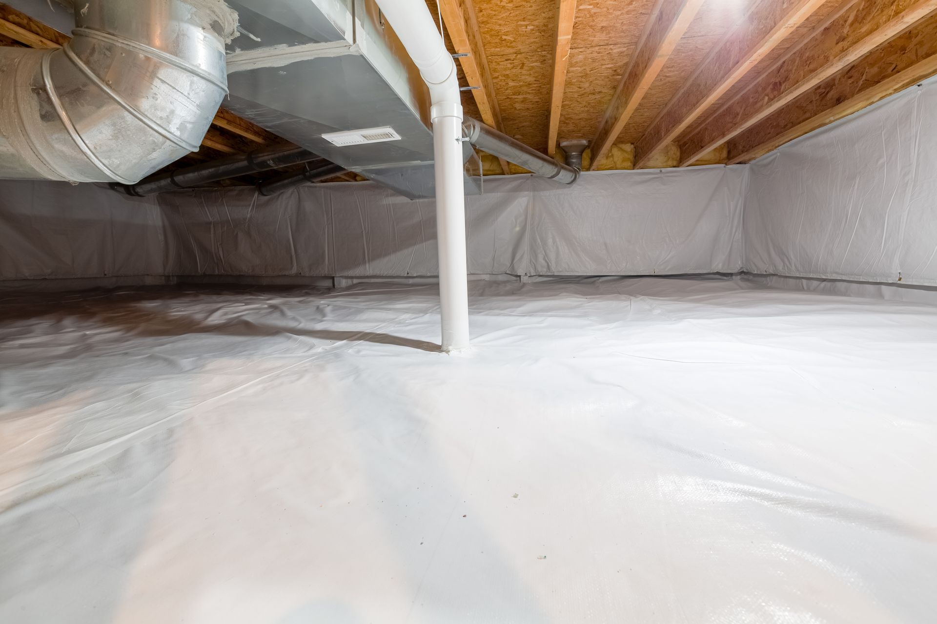 Unfinished basement crawlspace with exposed insulation, ductwork, and plastic vapor barrier floor