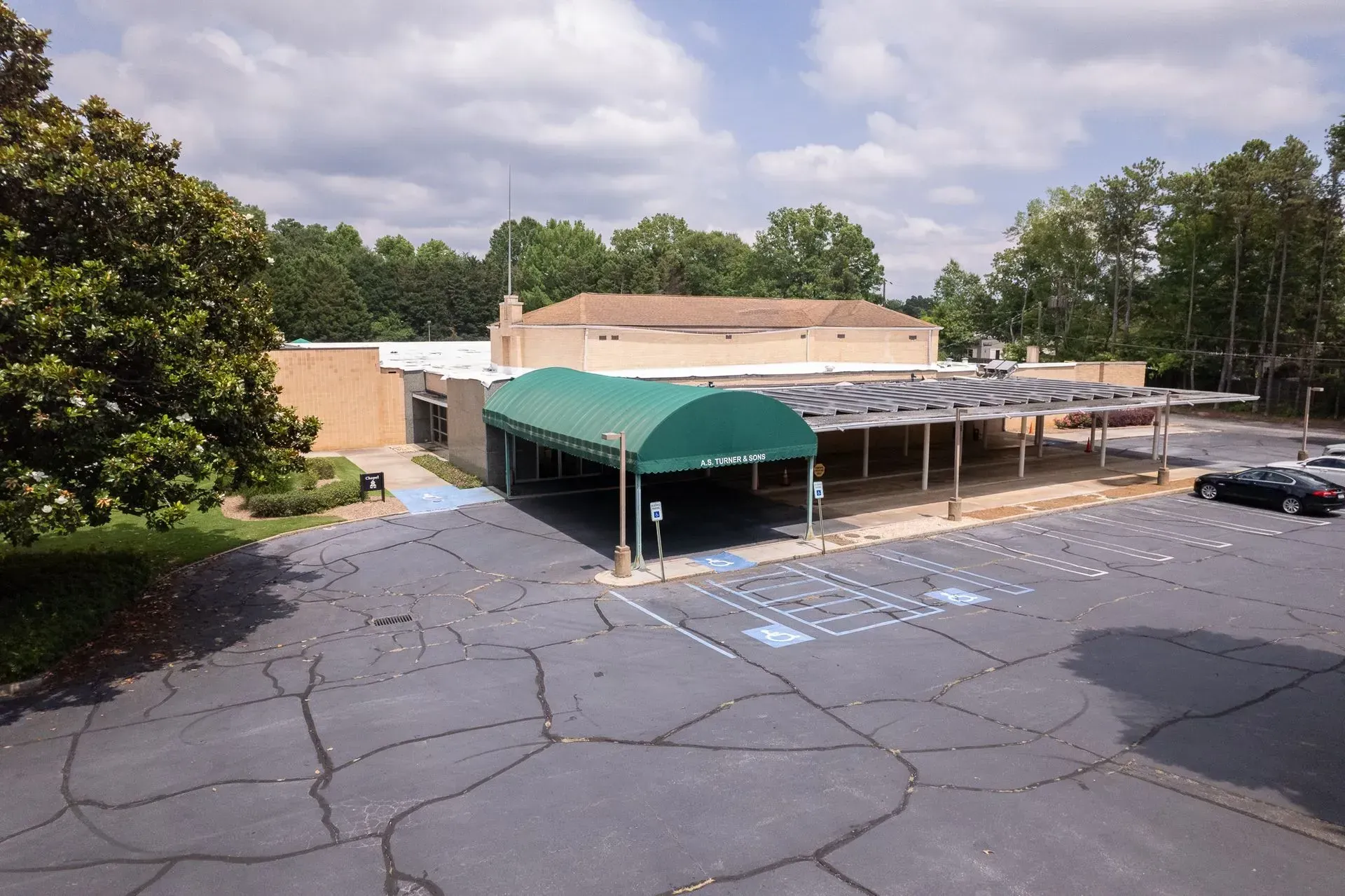 A large office building with a lot of windows on a sunny day.