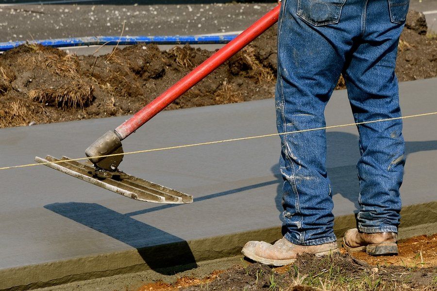 worker holding a concrete trowel