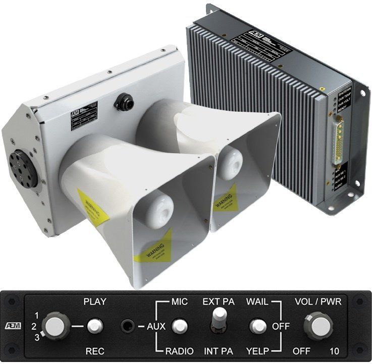 A couple of speakers sitting next to each other on top of a control panel.