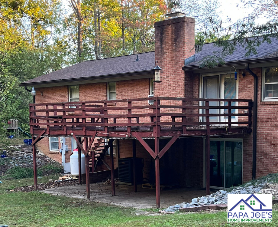 A brick house with a wooden deck in front of it