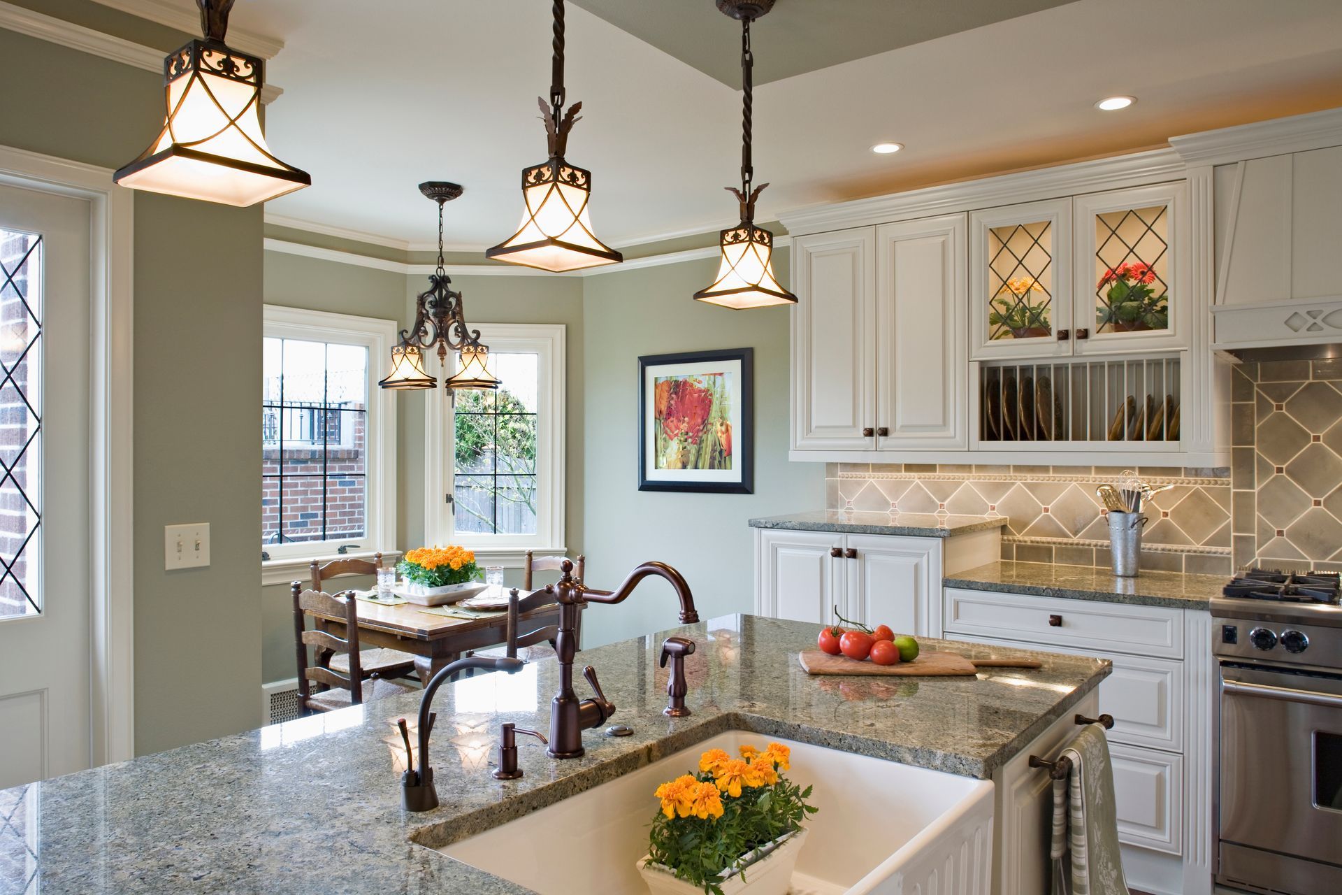 A kitchen with white cabinets and granite counter tops