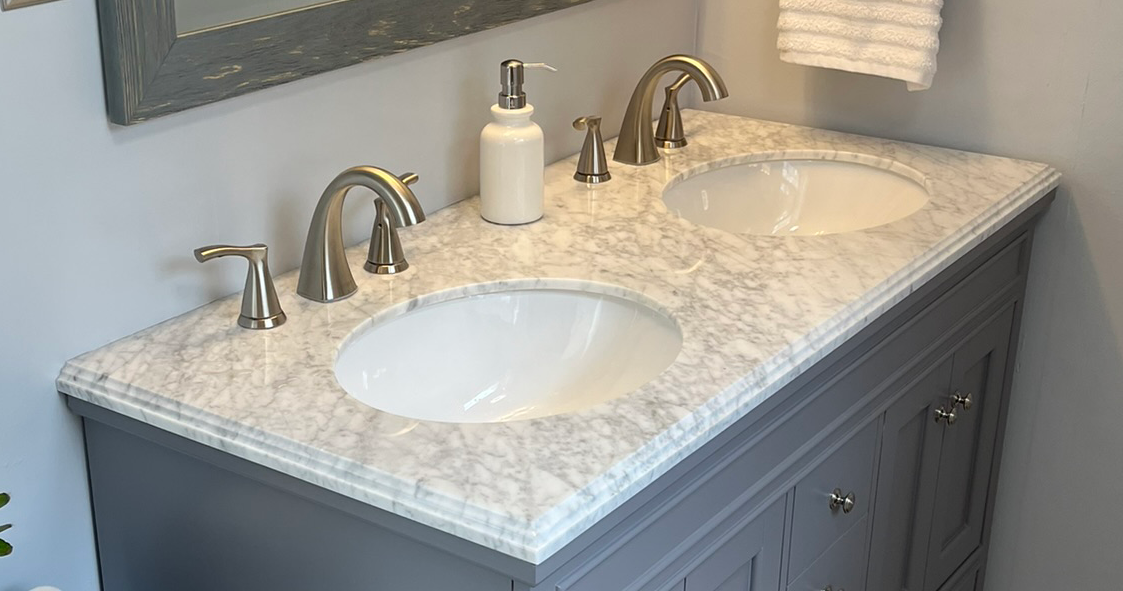A bathroom vanity with two sinks and a mirror.