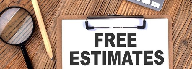 A clipboard with the words `` free estimates '' on it is on a wooden table.