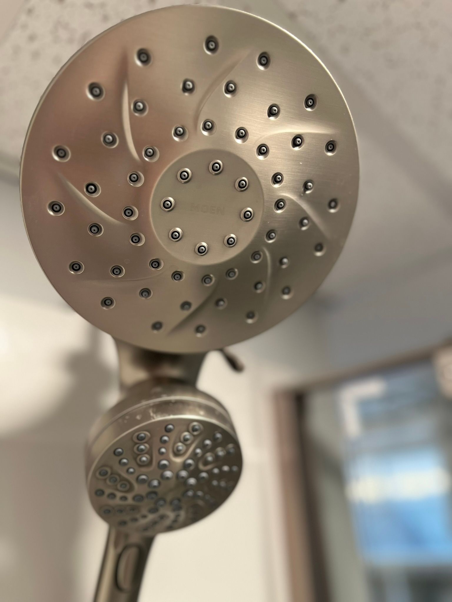 A close up of a shower head with holes in it