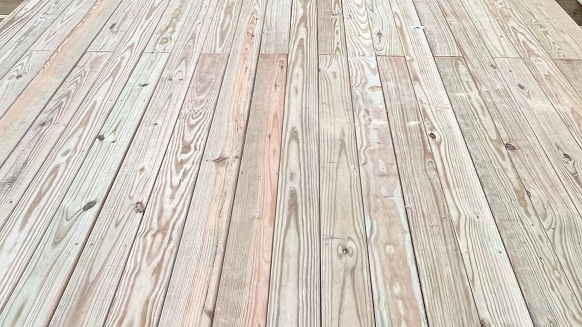A close up of a wooden deck with a lot of boards.