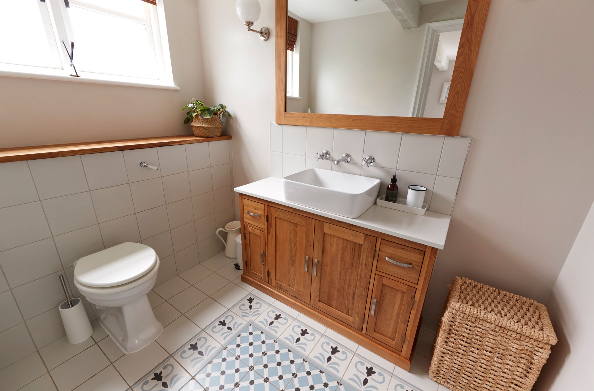 A bathroom with a toilet , sink and mirror