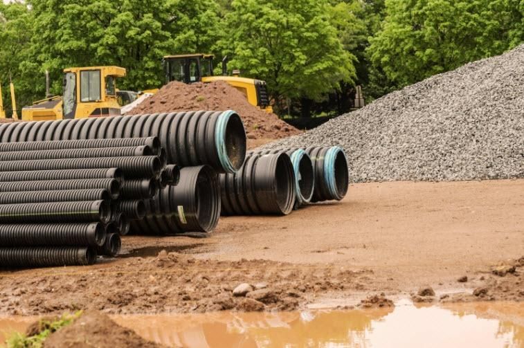 A Pile of Pipes Stacked on Top of Each Other on a Site — CWD Group in Springwood, QLD