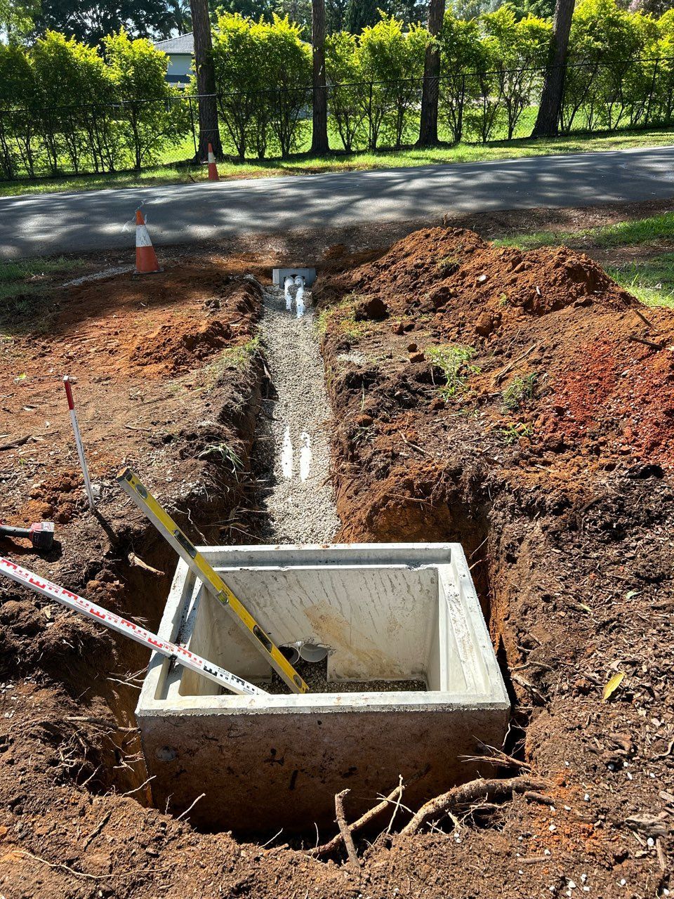 A Drain on the Side of a Road is Filled With Water — CWD Group in Springwood, QLD