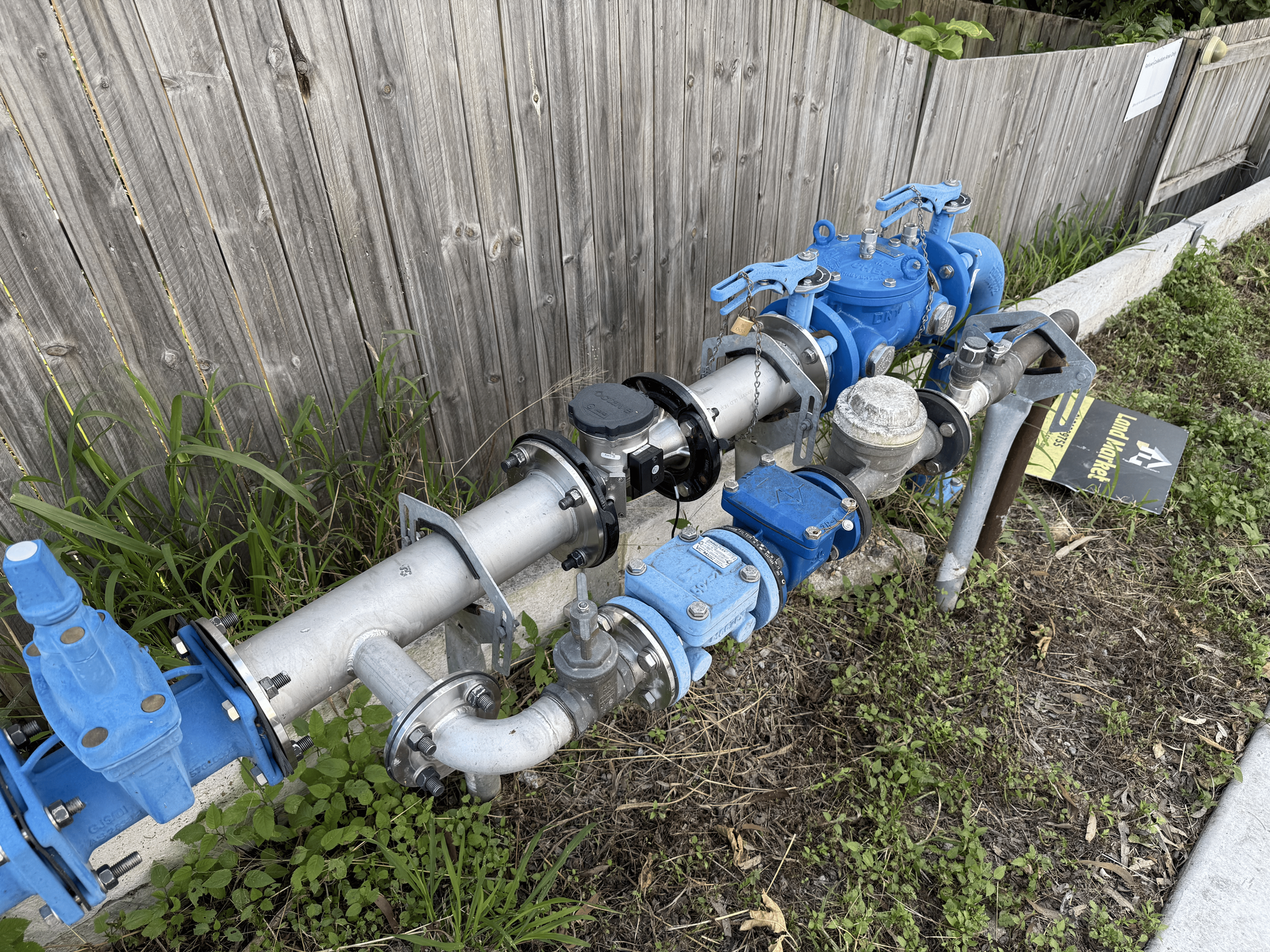 A Waste Water Pipe is Running Along a Fence — CWD Group in Springwood, QLD