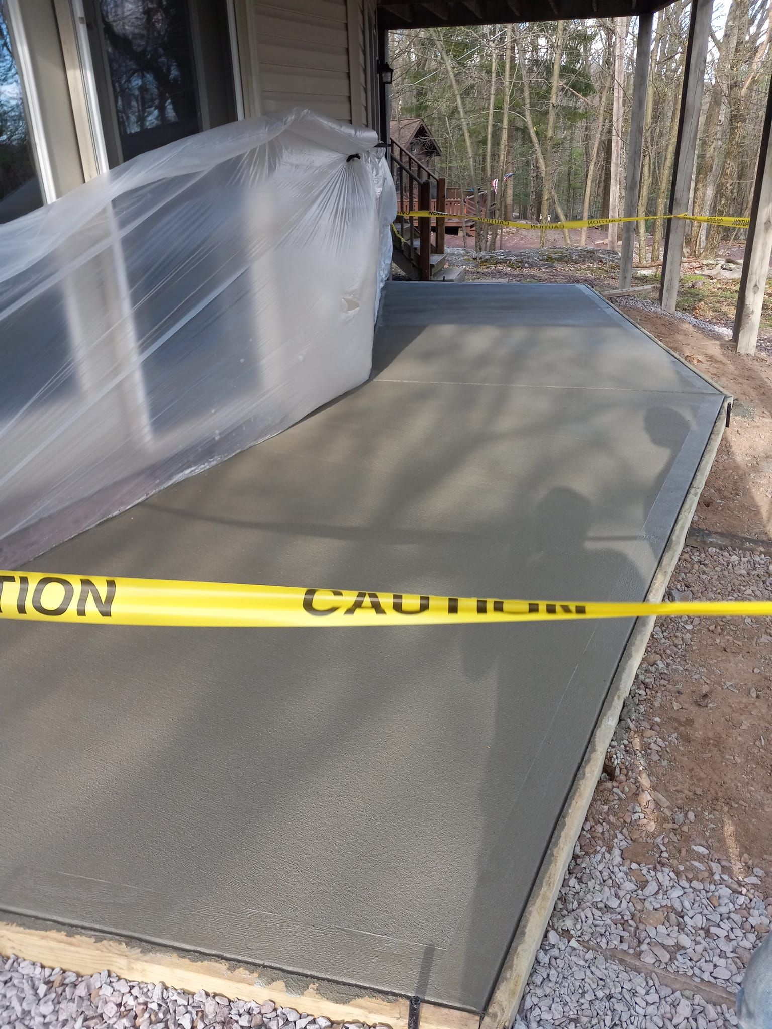 A concrete walkway is being built in front of a house.