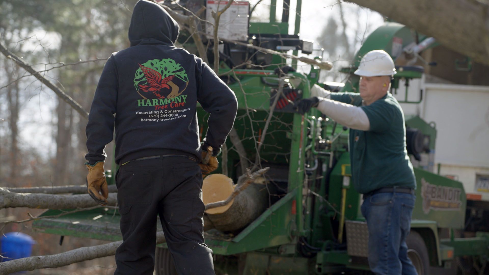 A man and a woman are working on a machine.