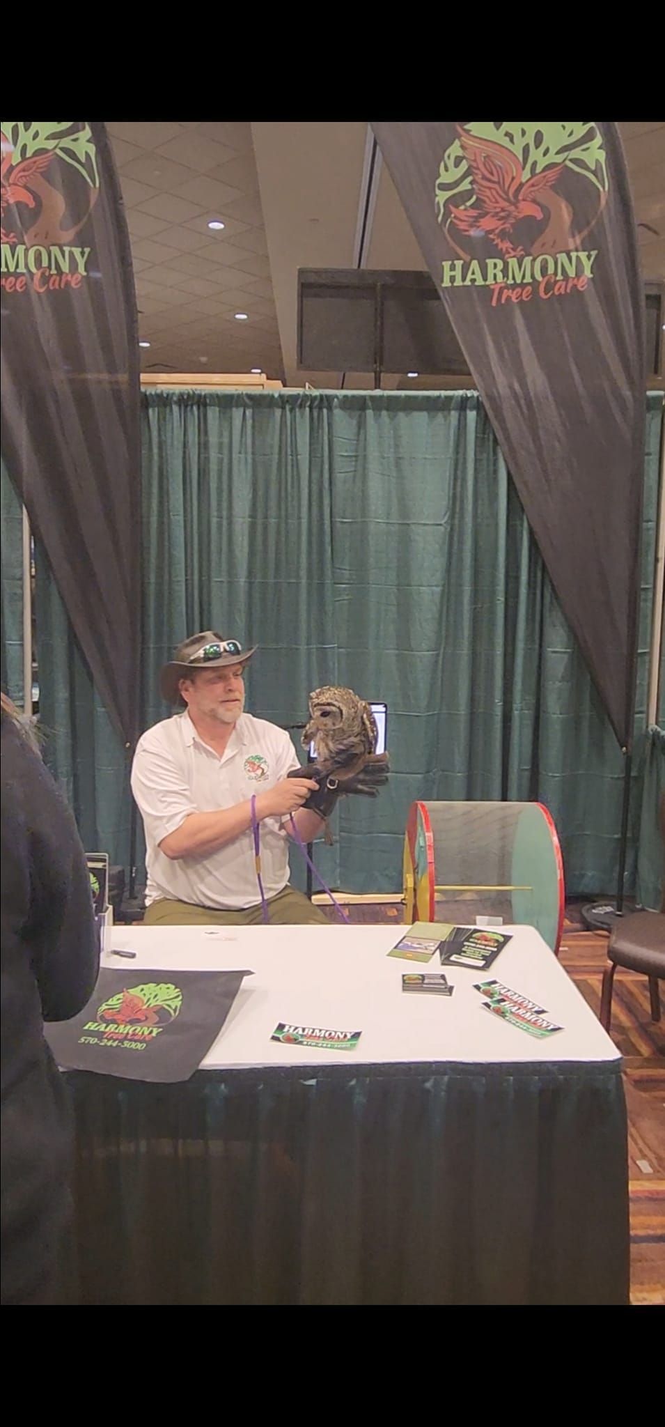 A man is sitting at a table holding a stuffed animal.
