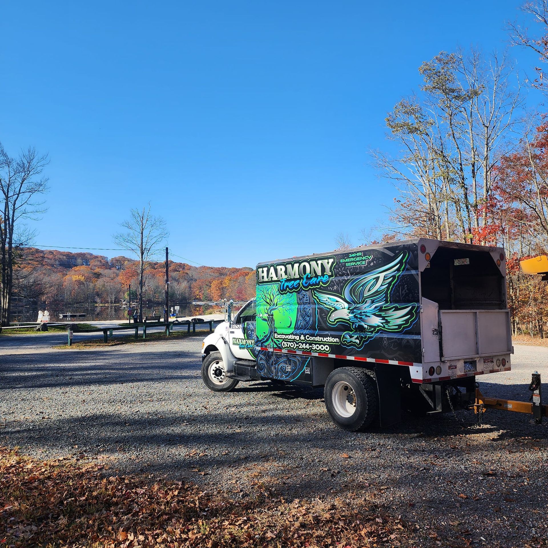 A harmony truck is parked in a gravel lot