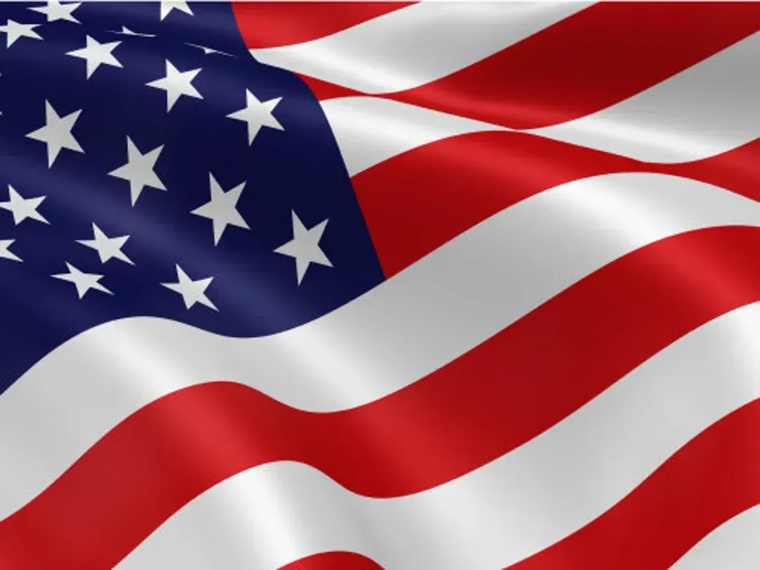 A close up of an american flag waving in the wind