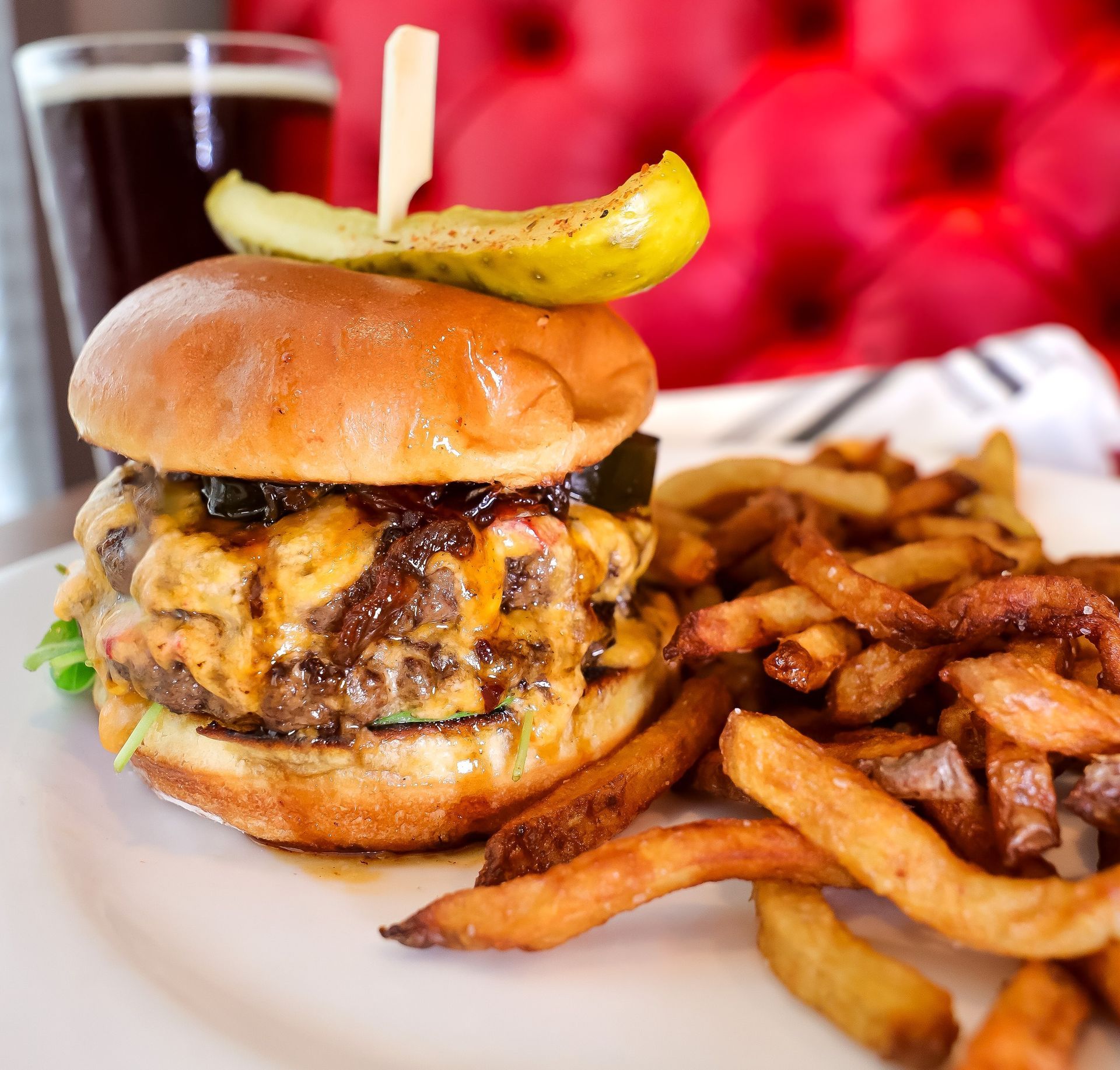 A glass of drink with lemon slices on a wooden table.