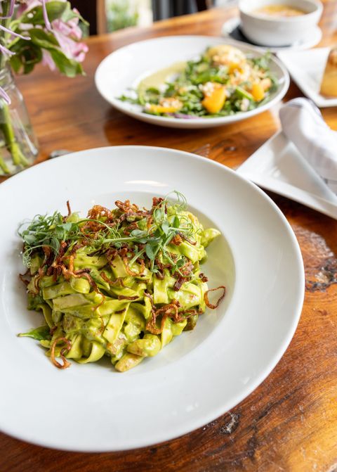 A close up of a plate of food on a wooden table.
