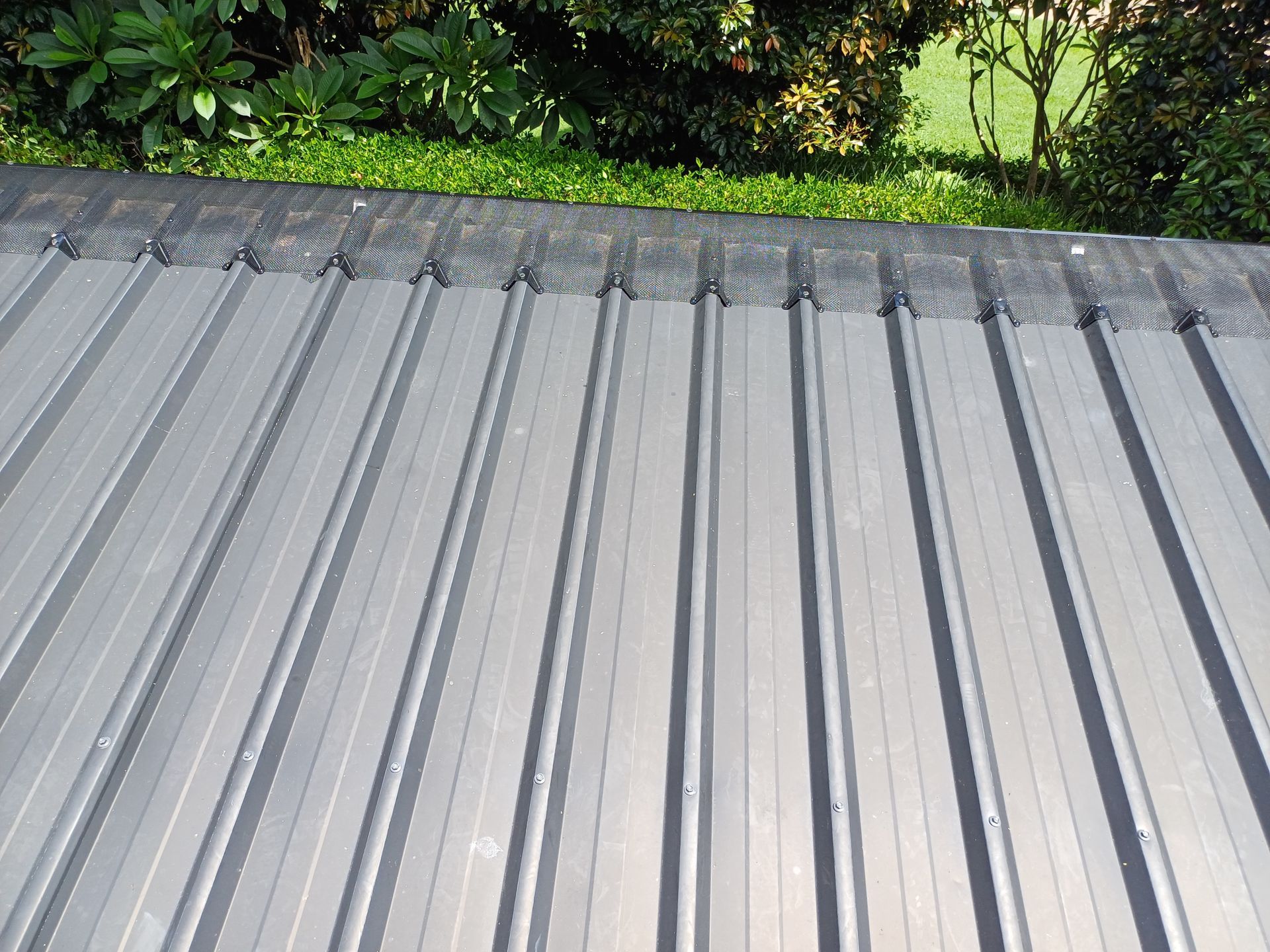 A Grey Roof with A Window on Top of It — Rooftech Roofing Services in Byron Bay, NSW