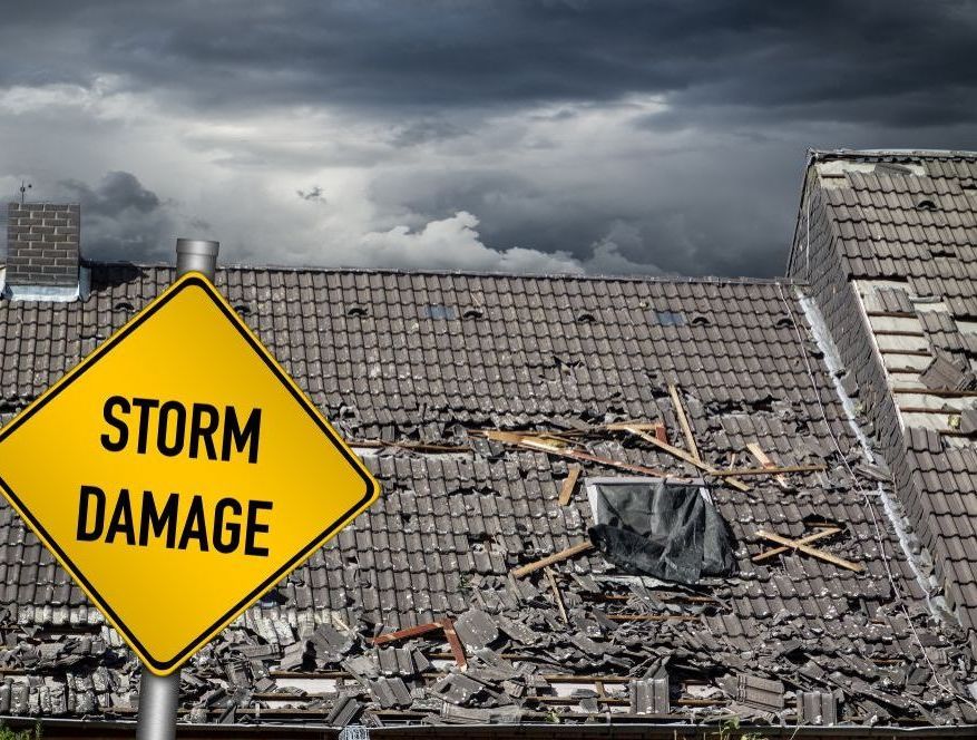 A Yellow Sign That Says  Storm Damage — Rooftech Roofing Services in Ballina, NSW