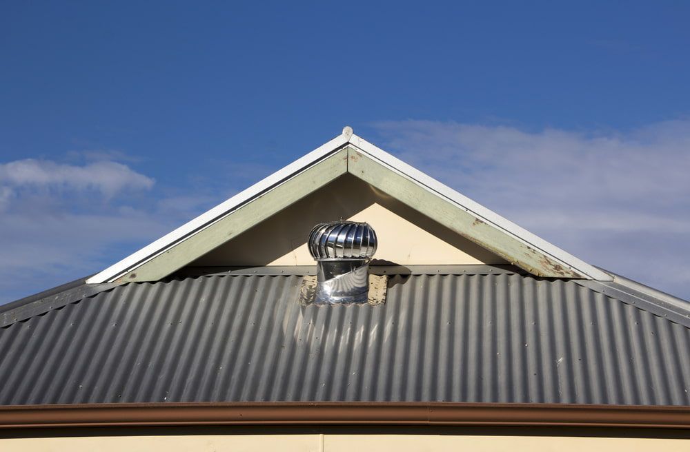 The Roof of A House with A Wind Turbine on It — Rooftech Roofing Services in Goonellabah, NSW