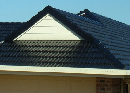 A House With A Black Roof And A White Trim — Rooftech Roofing Services in Ballina, NSW